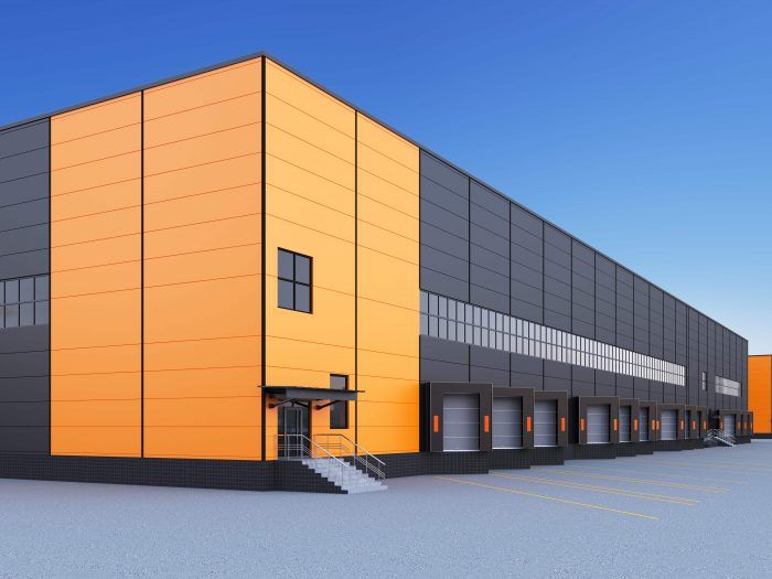 Modern warehouse building with a black and orange facade.